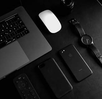 jet black iPhone 7 beside analog watch