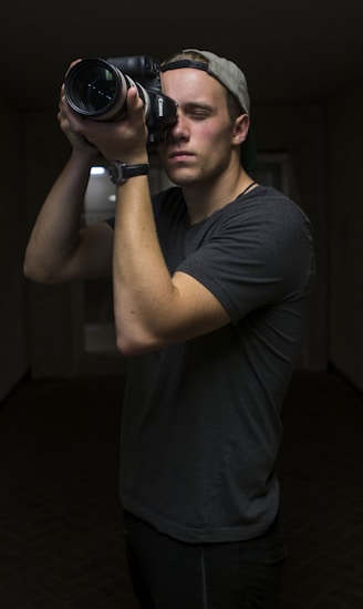 man taking photo using Canon DSLR camera